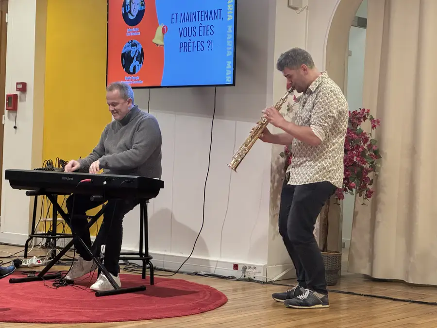 Un pianiste et un saxophoniste improvisent devant les participants